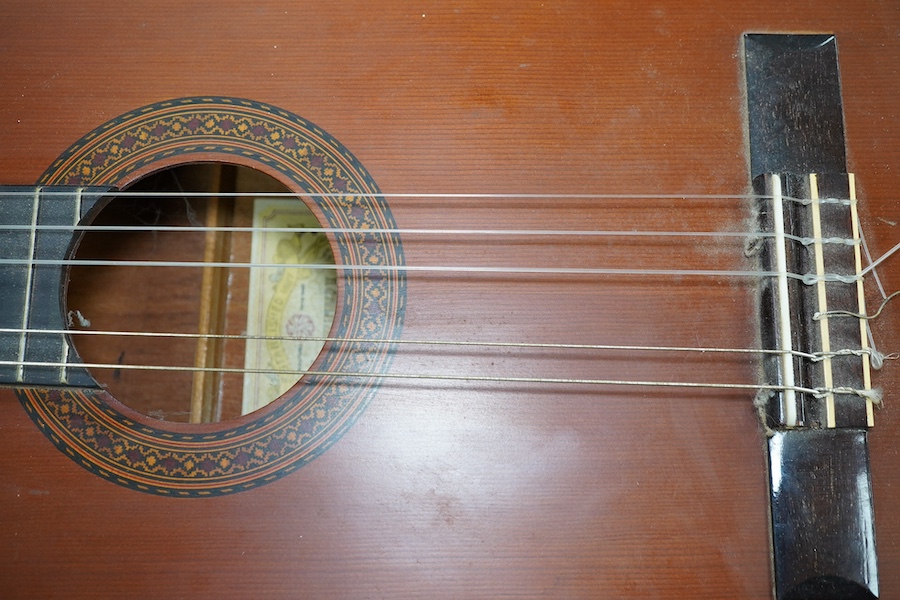 A Suzuki classical guitar, no.3067. Condition - fair, one string missing and scratches to the body.